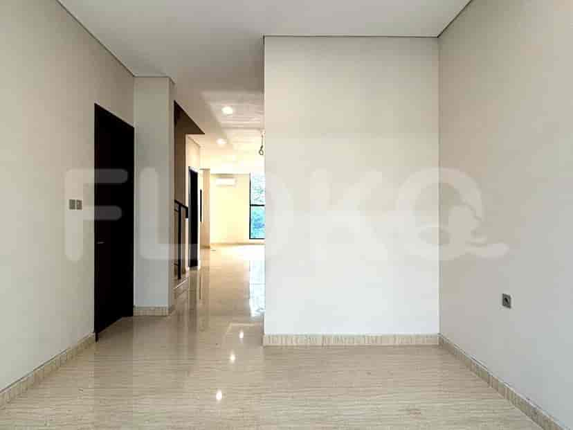 A corridor with marble flooring, dark doors, and white walls.