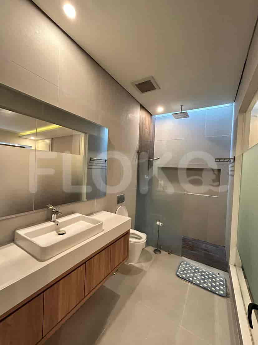 A modern bathroom with a sink, mirror, and a shower.
