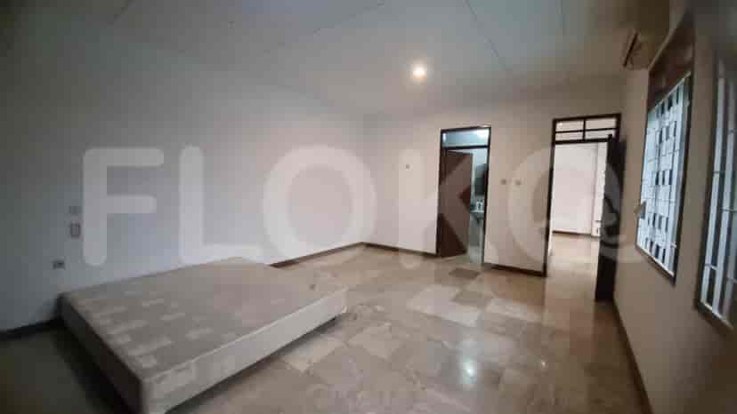 A bedroom with marble flooring, a built-in wardrobe, and windows.
