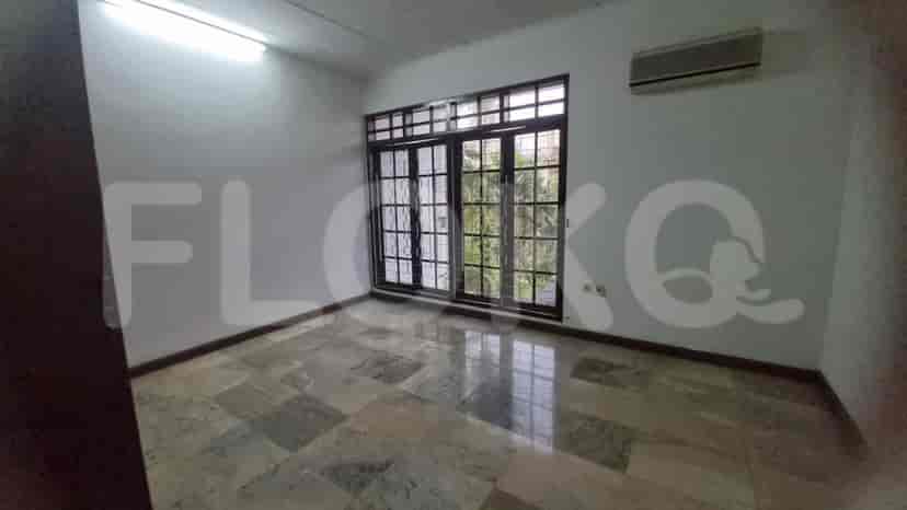 A bedroom with marble flooring and large windows.