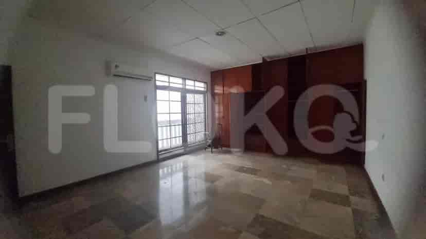 A large bedroom with marble flooring, built-in wardrobe and windows.