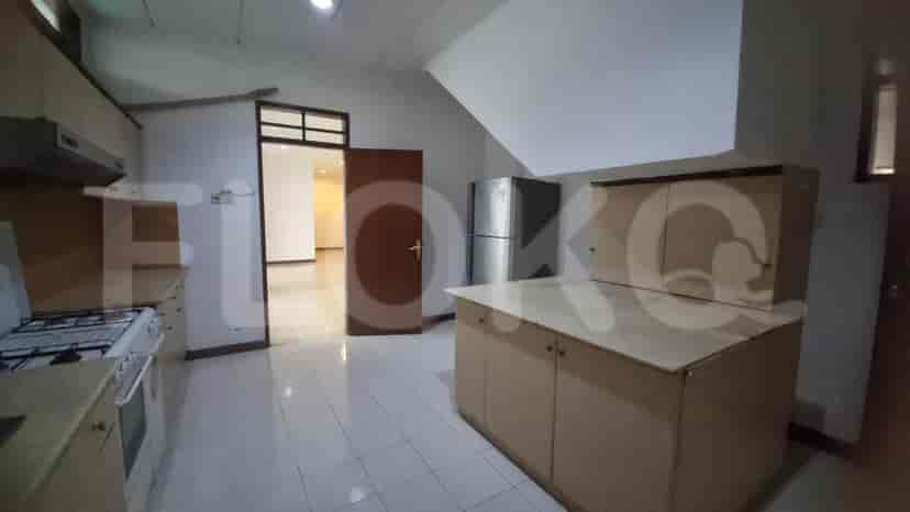 A kitchen with cabinets, appliances, and a door.
