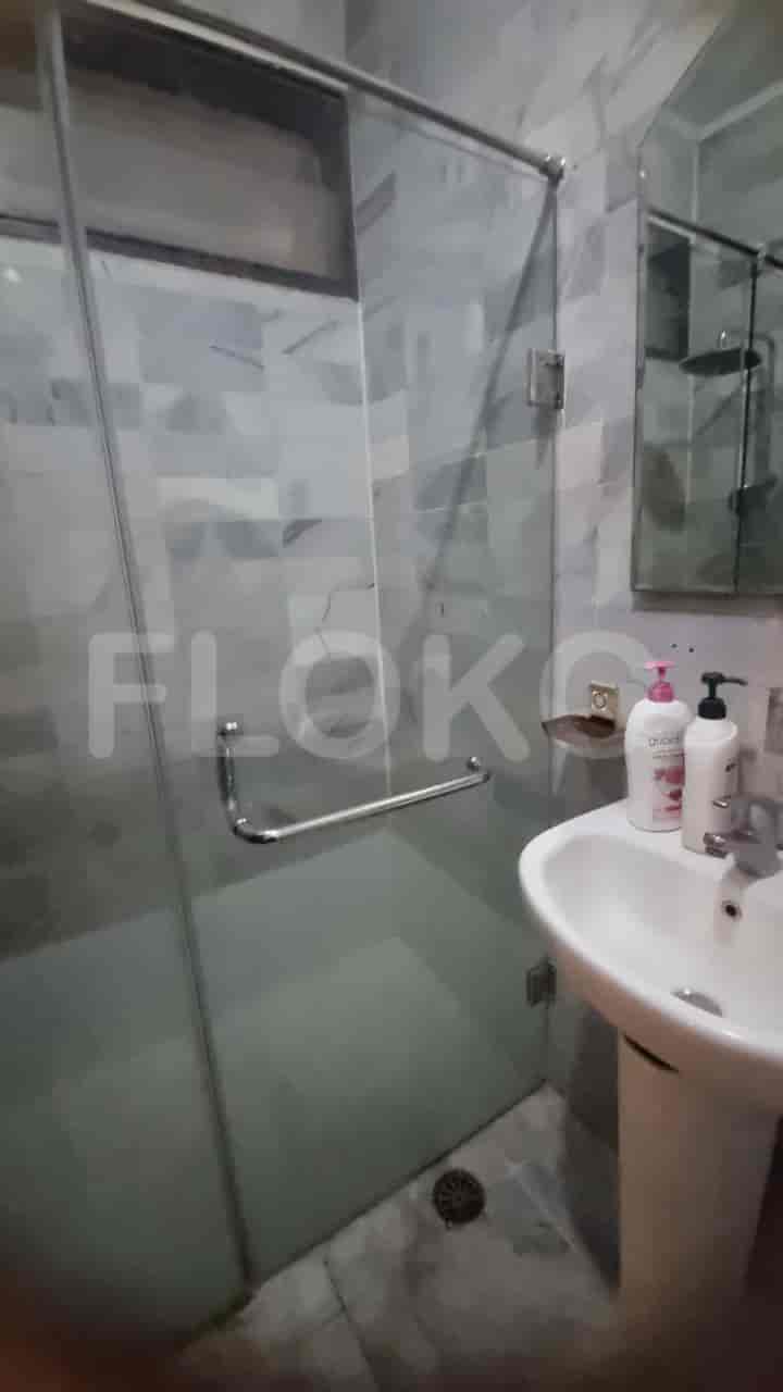 A bathroom with a shower and a sink.
