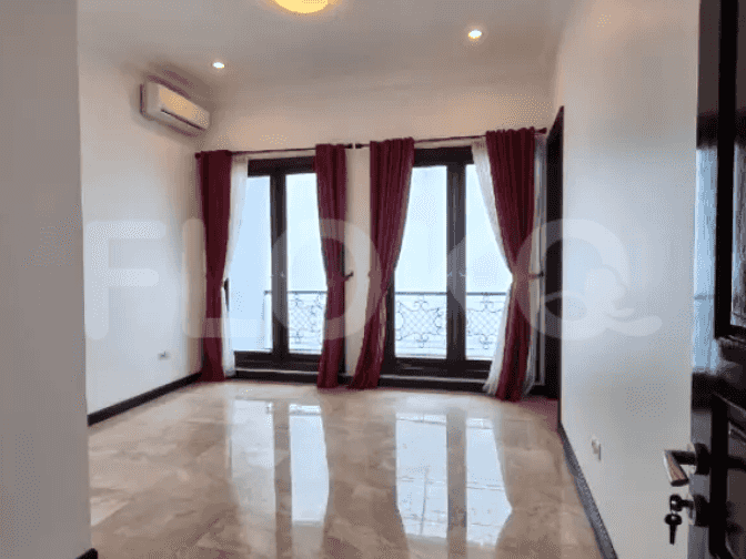 A bedroom featuring marble flooring, white walls, and large windows with sheer curtains and red blackout curtains.