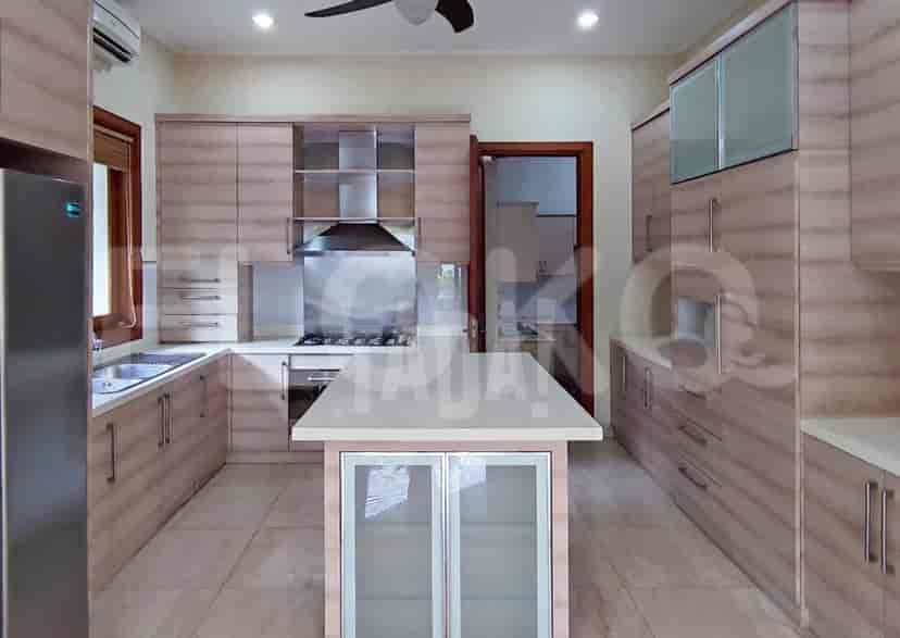 A modern kitchen with light wood cabinetry, a center island, and marble flooring.