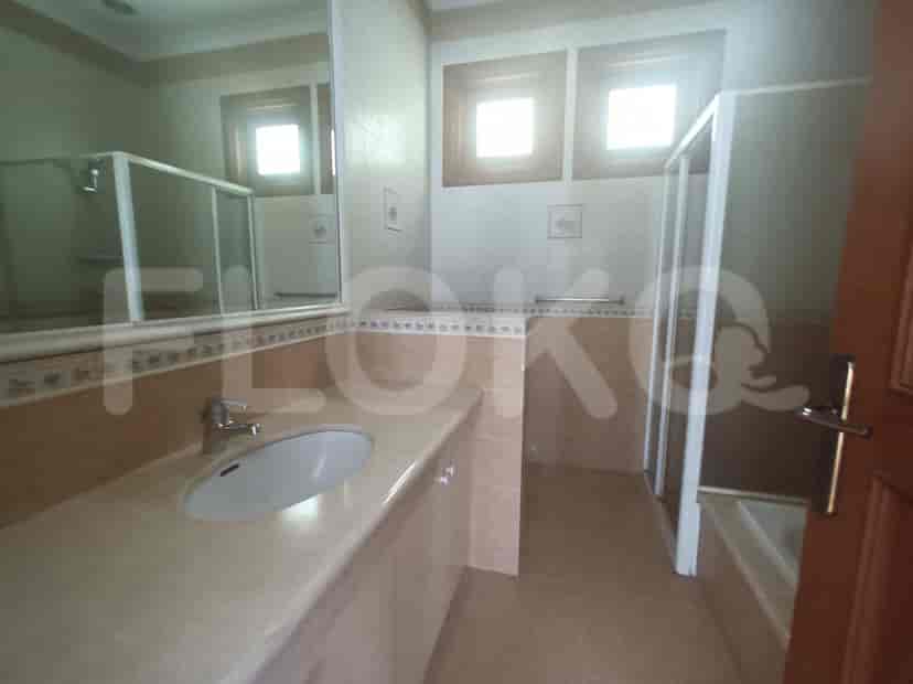 A bathroom with a vanity, mirror, and shower stall.