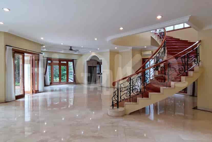 An expansive living room with large windows, a staircase, and marble flooring.