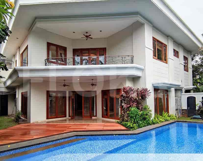 A view of the house's exterior with a swimming pool and wooden deck.