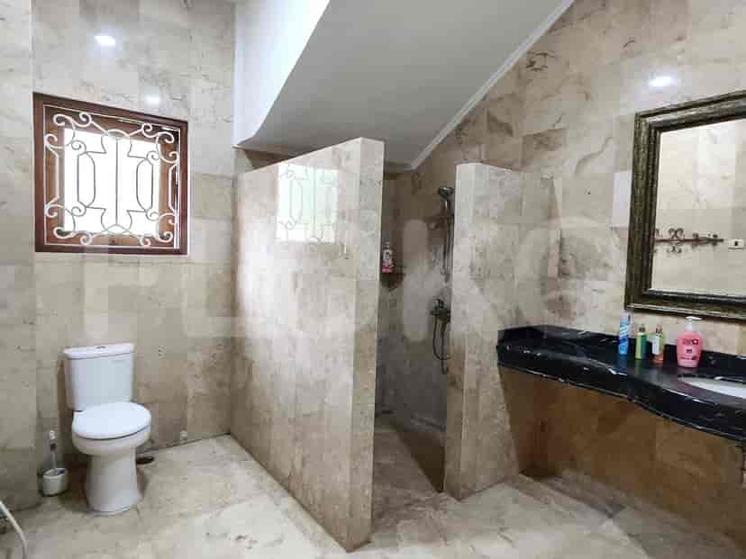 A bathroom featuring a shower stall and a marble tile design.