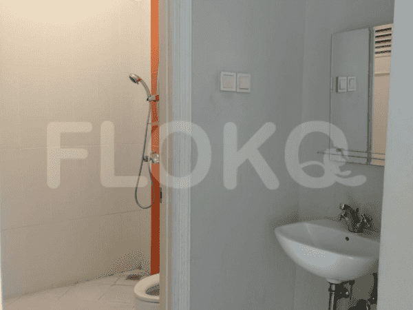 A small bathroom equipped with a shower, toilet, and a sink.