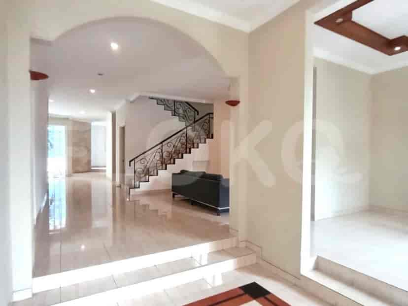 The interior entrance of the house with stairs leading to the upper floor and a sofa.