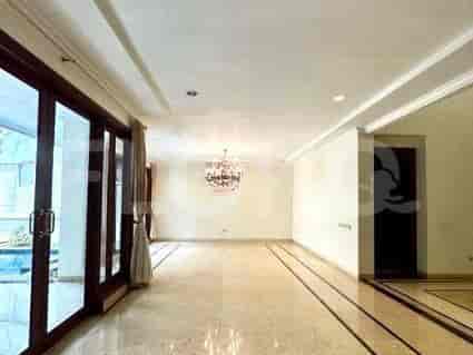 An open living room with marble flooring, a chandelier, and large glass sliding doors.