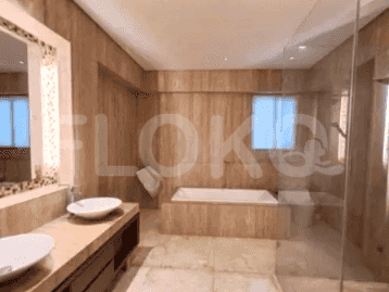 A modern bathroom showcasing a walk-in shower with a glass enclosure, a vanity with a vessel sink, and a toilet.