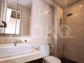 A spacious bathroom with dual vessel sinks, a large mirror, and a toilet.