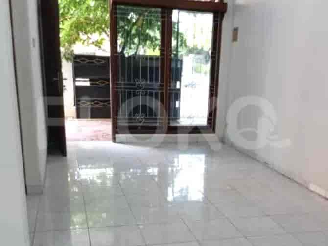 A room with tiled flooring, sliding glass doors, and an open doorway.