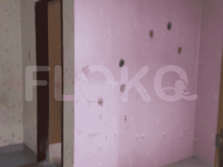 A bedroom with pink wallpaper and a partially visible doorway.