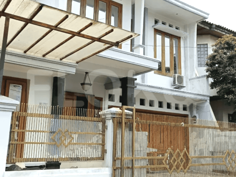 A two-story modern house with a white exterior, wooden accents, and a gated entrance.
