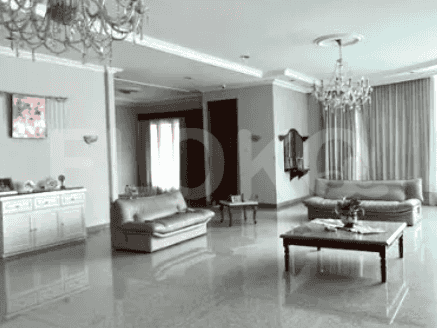 A large living room with marble floors, multiple seating areas, and two chandeliers.