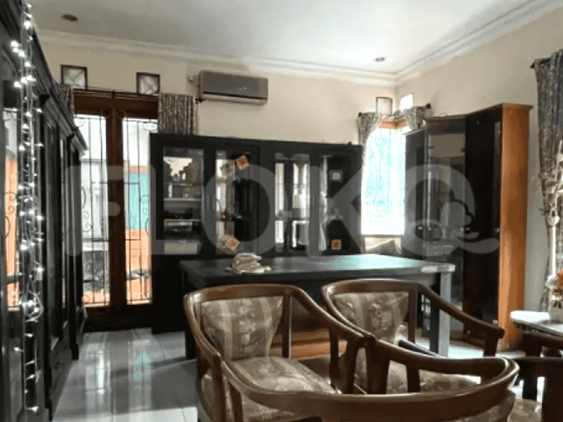 Living room / dining area with dark wood furniture, tiled floors and air conditioning.