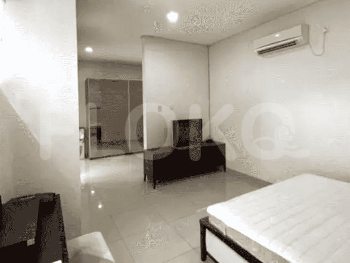 A bedroom featuring a queen bed, wardrobe, and an air conditioning unit mounted on the wall.