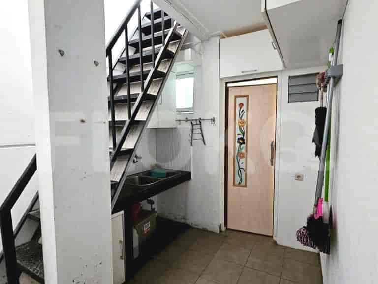 Service area including a small kitchen area under the staircase.