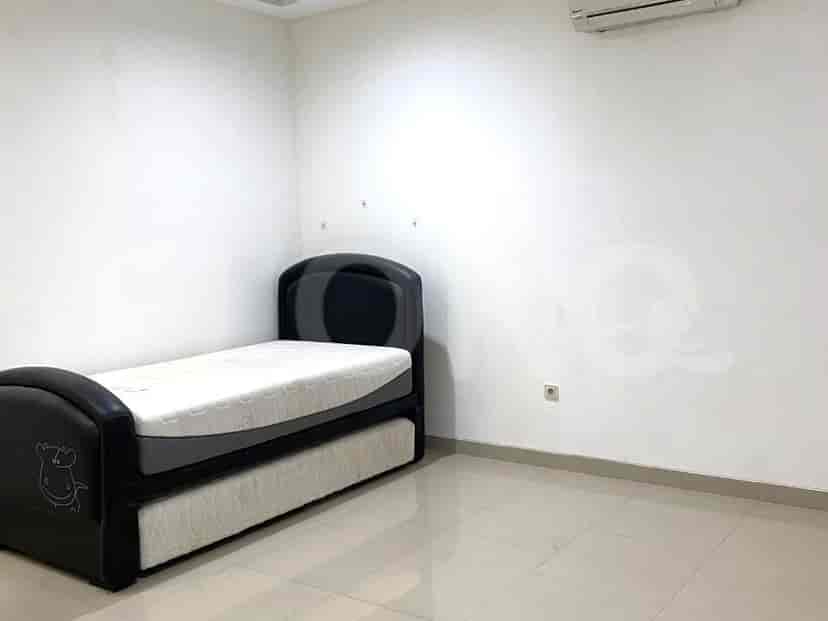 A bright bedroom with a single bed and air conditioning.