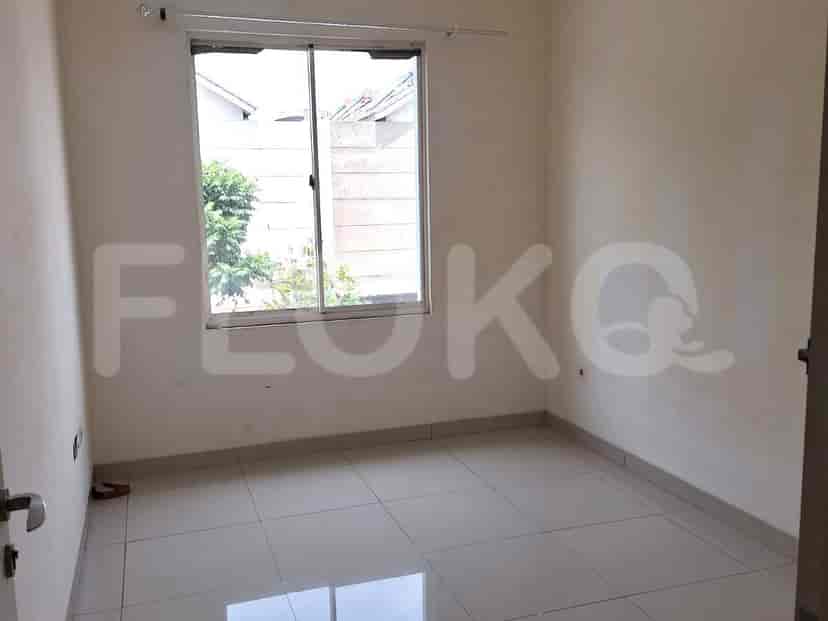A bedroom with a window and tiled floor.
