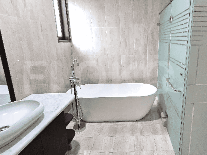 A modern bathroom with a standalone bathtub, a glass shower enclosure, and a vanity unit.