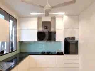A modern kitchen with white cabinets, a black countertop, and built-in appliances.