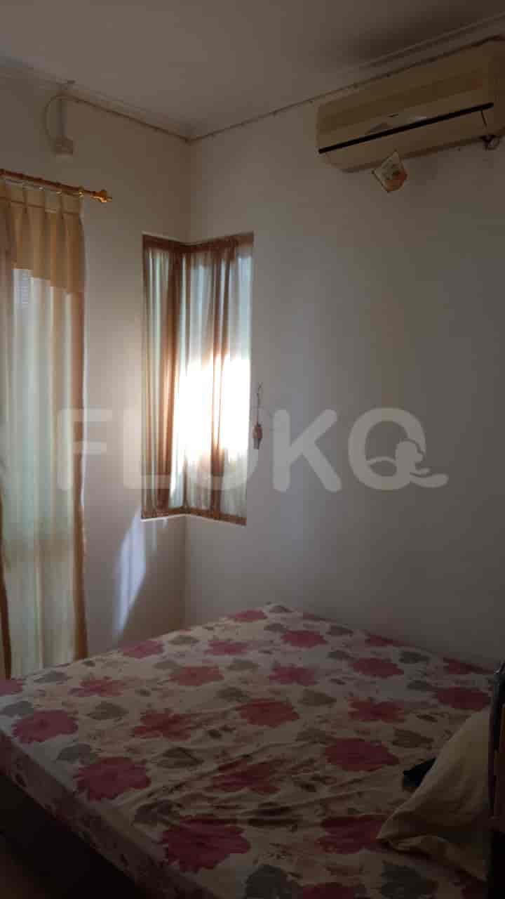 A bedroom with a double bed, curtains, and an air conditioning unit.