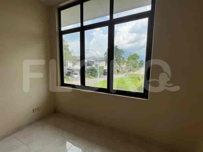 Empty bedroom with a window that has a view.