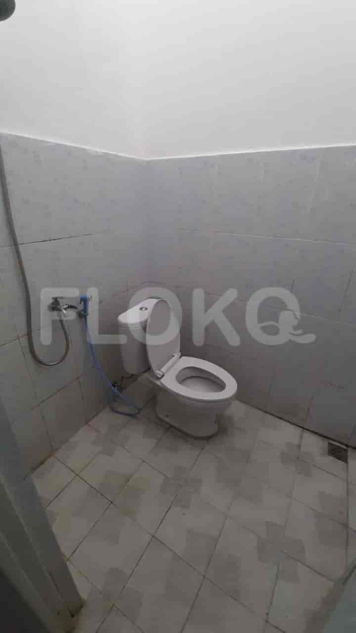 A bathroom with a Western style toilet and a shower.