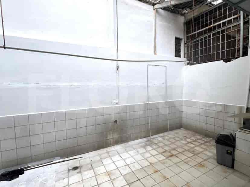A laundry room with tiled floors, white walls, and an open area for washing and drying.