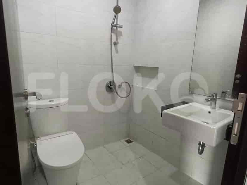 A bathroom with a toilet, sink, and shower.