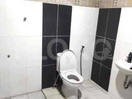 A bathroom with a toilet, sink and shower.