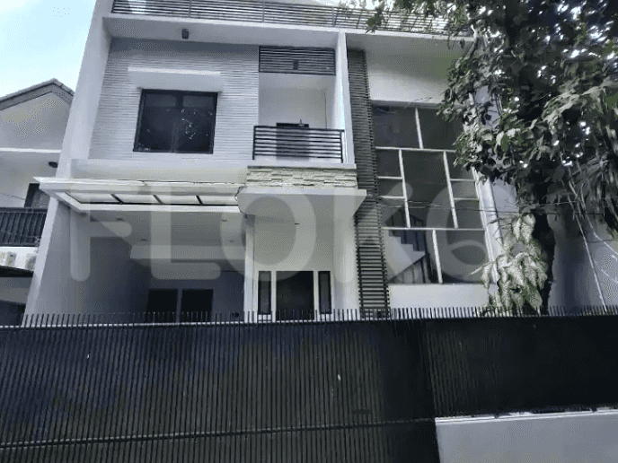 A modern two-story house with a black fence, carport, and balcony.