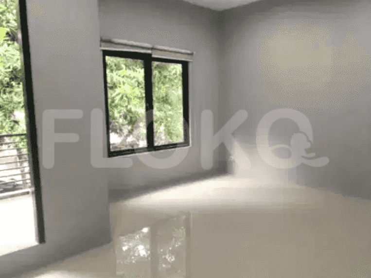 A bedroom with a large window and grey walls.