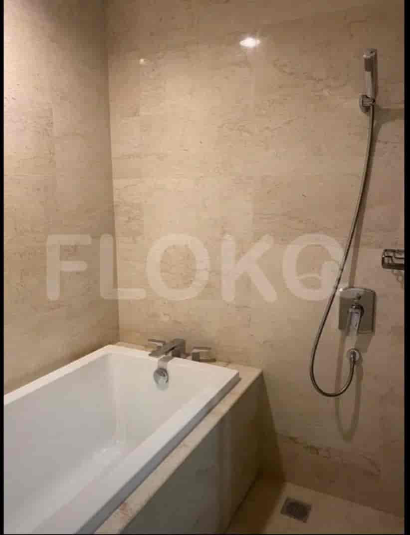 The bathroom is tiled with a bathtub and shower.