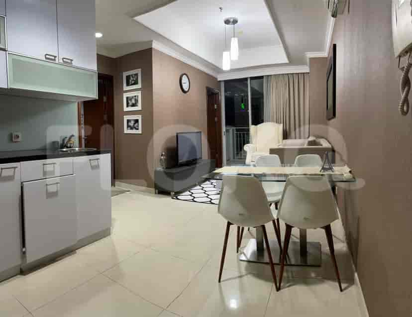A modern living space with a kitchen and a dining area.