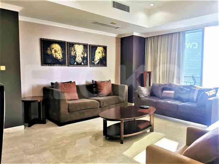 Living room with brown sofas, art, and a coffee table.