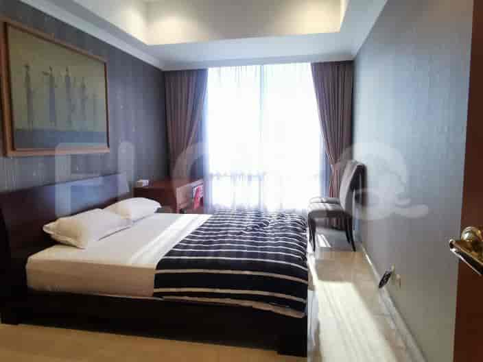 Bedroom with a bed, artwork, and a window.