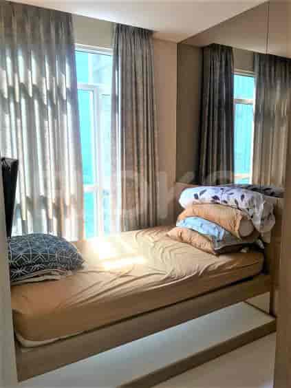 Bedroom with bed, curtains and mirror.