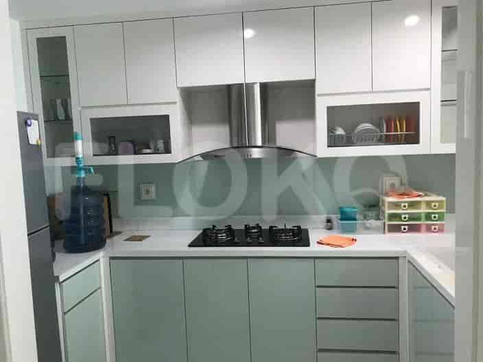 A modern kitchen with cabinets, a stove, and a range hood.
