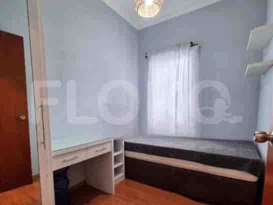 Compact bedroom with a bed, desk, and closet access.
