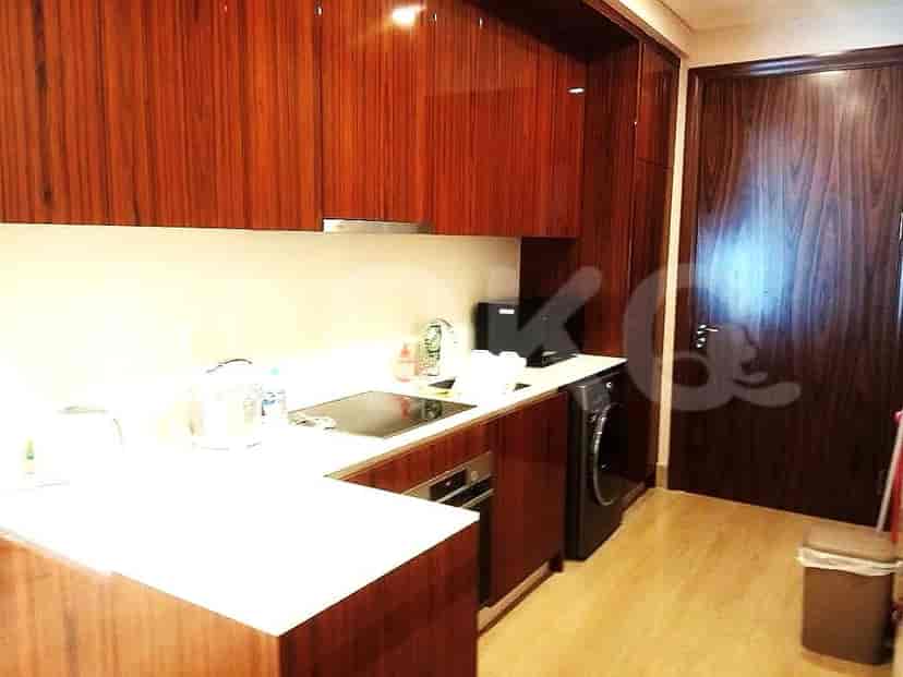 Modern kitchen with wooden cabinetry and white countertops.