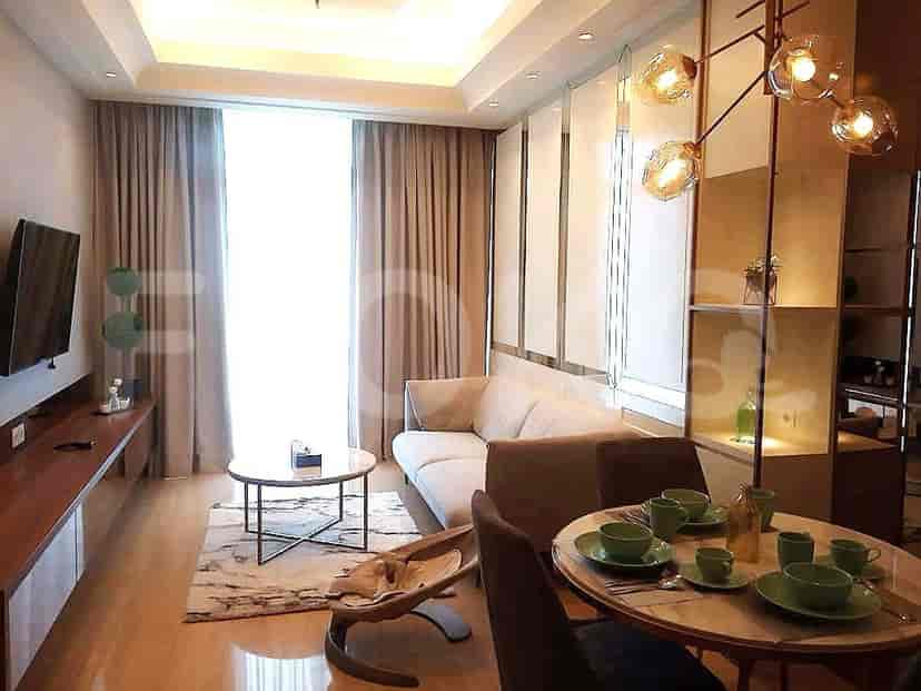 Living room with a sofa, coffee table, and curtains.