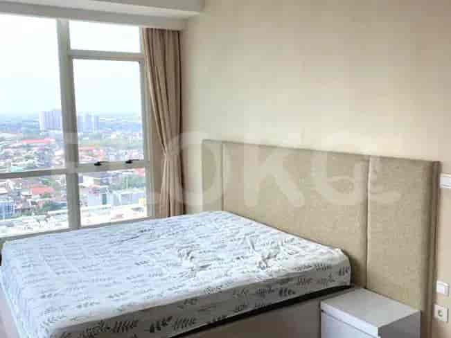 Bedroom with a double bed, large windows, and curtains.