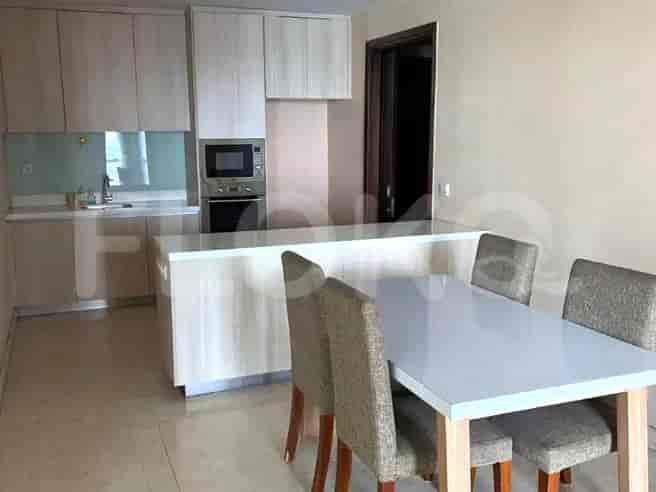 Modern dining area with a kitchen island, dining table with chairs, and cabinetry.
