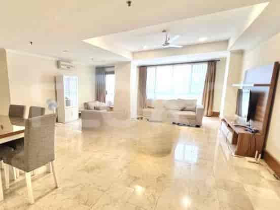 Spacious living room with a sofa, dining area, and marble flooring.