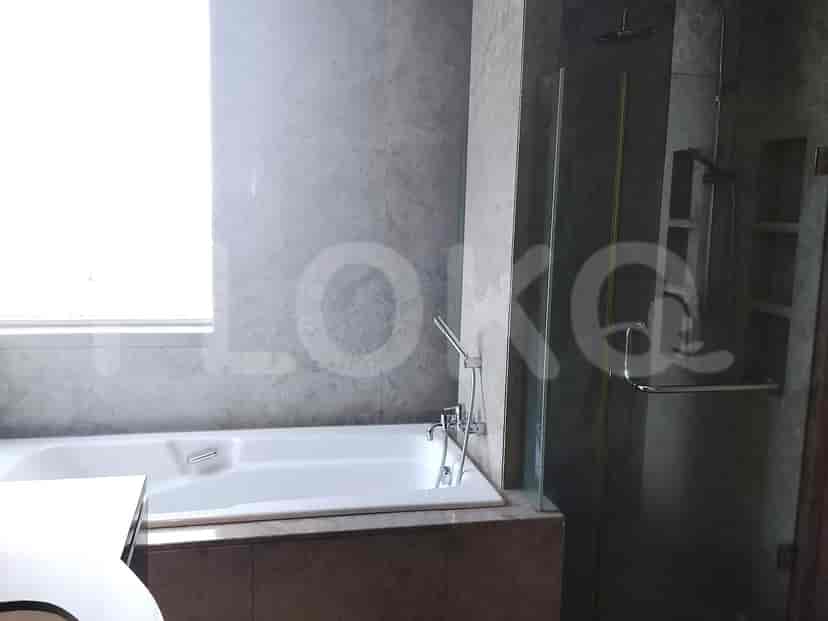 A modern bathroom featuring a bathtub, shower, and large window.